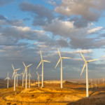 Windmills at Tehachapi Pass Wind Farm, California, generating clean renewable electrical energy without carbon dioxide emissions to fight climate change and global warming.